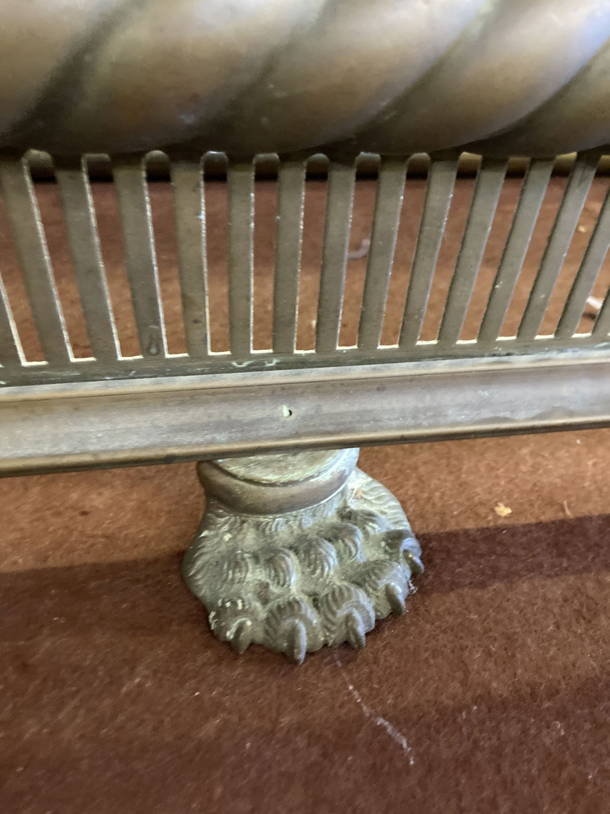 A Regency pierced brass kerb and an Edwardian brass kerb, larger 132cm wide, depth 36cm